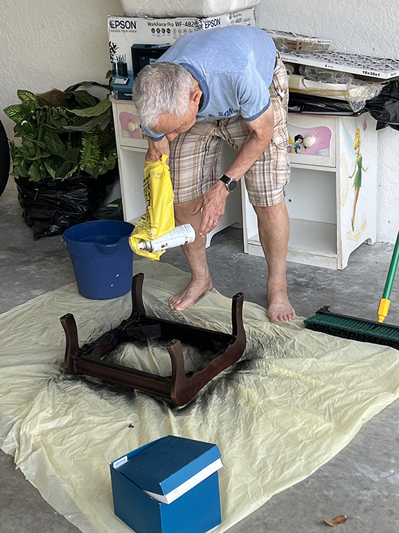 Stan spray painting the footstool